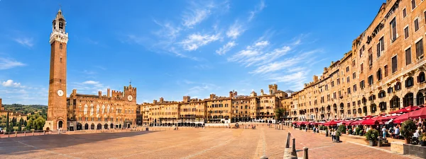 Panoramic view of Piazza del Campo and Torre del Mangia in Siena, historic location of the Palio di Siena horse race.