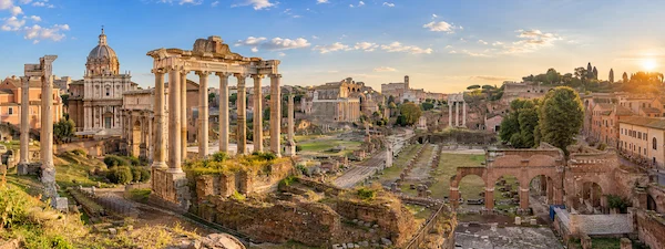 Roman Forum in Rome with ancient temple columns and archaeological ruins at sunset